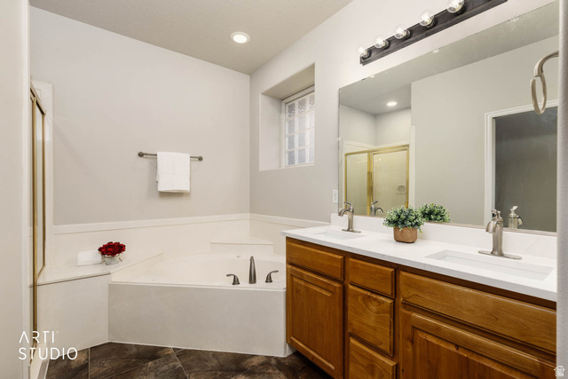 2158 Balboa Way St. George, UT 84770 - Photo 16 of 40 Full bath with a bath, double vanity, and a shower stall