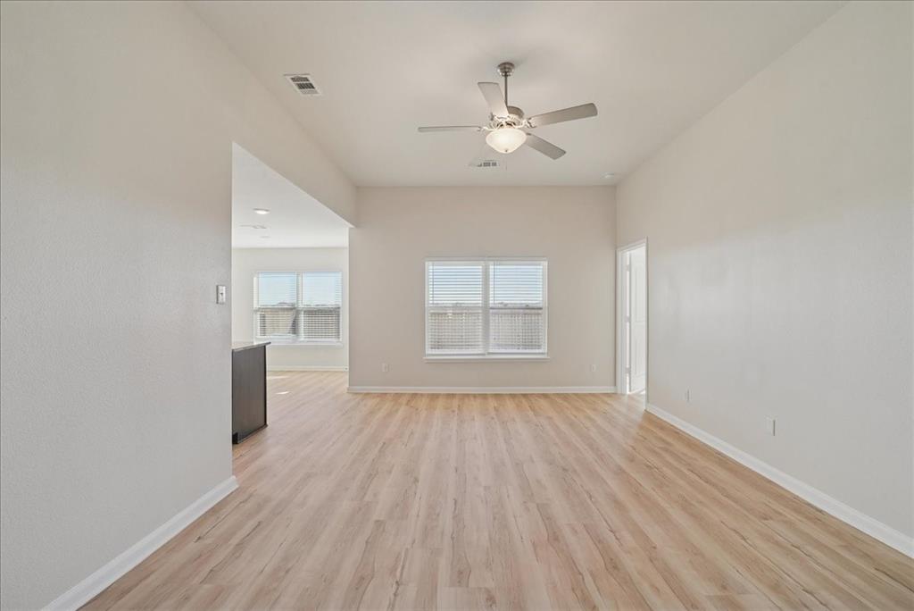 115 Sammy Fowler Avenue Venus, TX 76084 - Photo 11 of 34 a view of empty room with wooden floor and fan