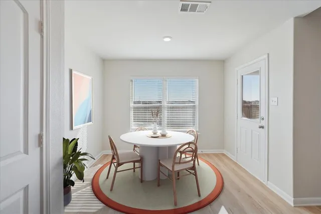 a dining room with a table and chairs