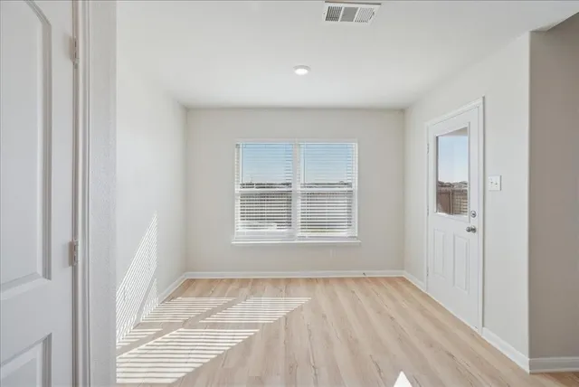 a view of an empty room with a window