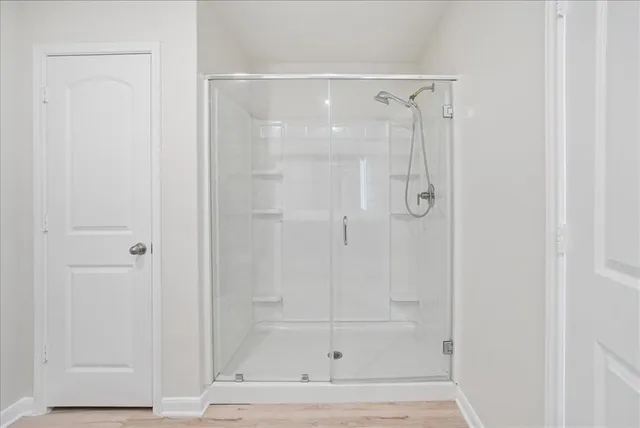 a bathroom with a glass shower door
