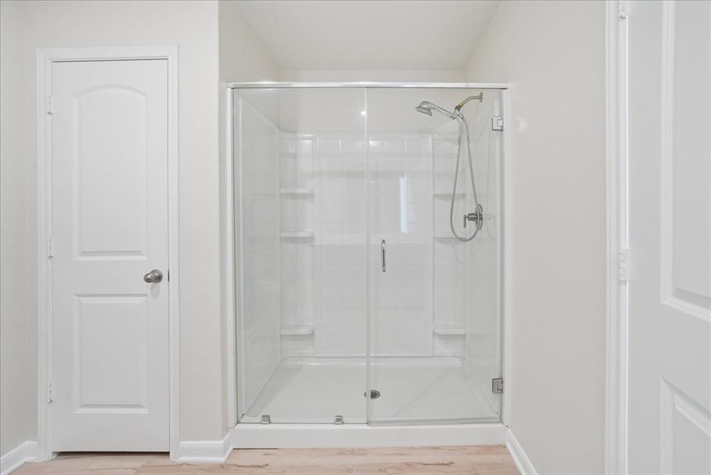115 Sammy Fowler Avenue Venus, TX 76084 - Photo 26 of 34 a bathroom with a glass shower door