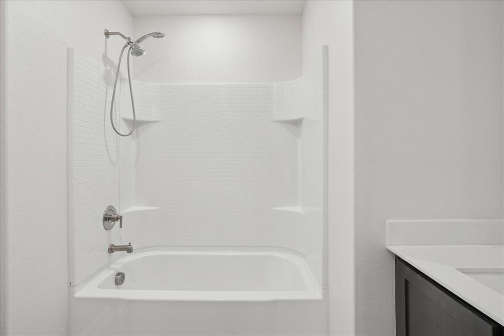 115 Sammy Fowler Avenue Venus, TX 76084 - Photo 6 of 34 a bathroom with a bath tub and a shower