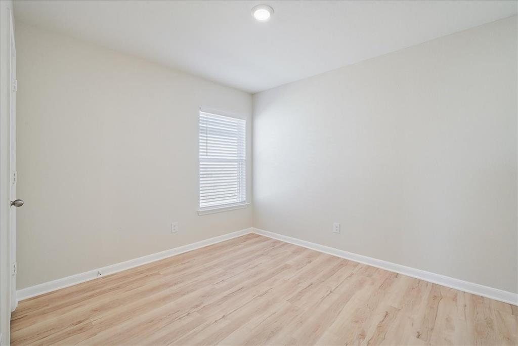 115 Sammy Fowler Avenue Venus, TX 76084 - Photo 7 of 34 an empty room with wooden floor and windows