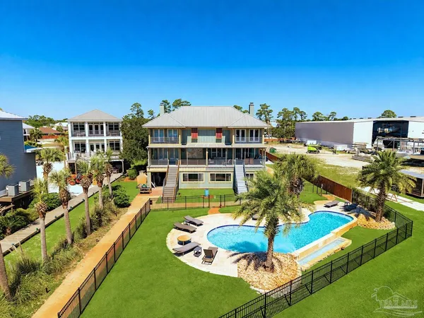 a view of a ocean with boats and trees in the background