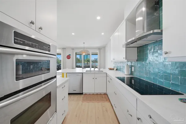 a bathroom with a granite countertop sink a toilet and a shower