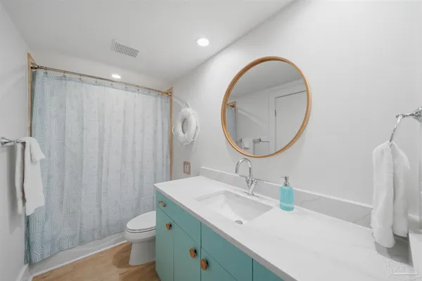 a spacious bathroom with a sink a mirror and a shower