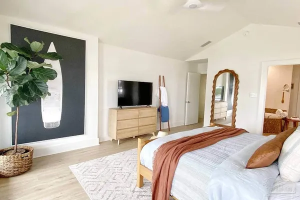 a kitchen with stainless steel appliances kitchen island granite countertop a stove a refrigerator and a dining table with wooden floor