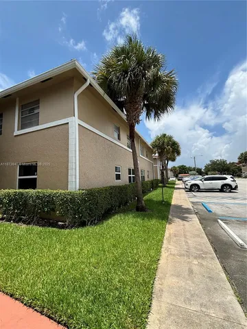 a view of a backyard with potted plants