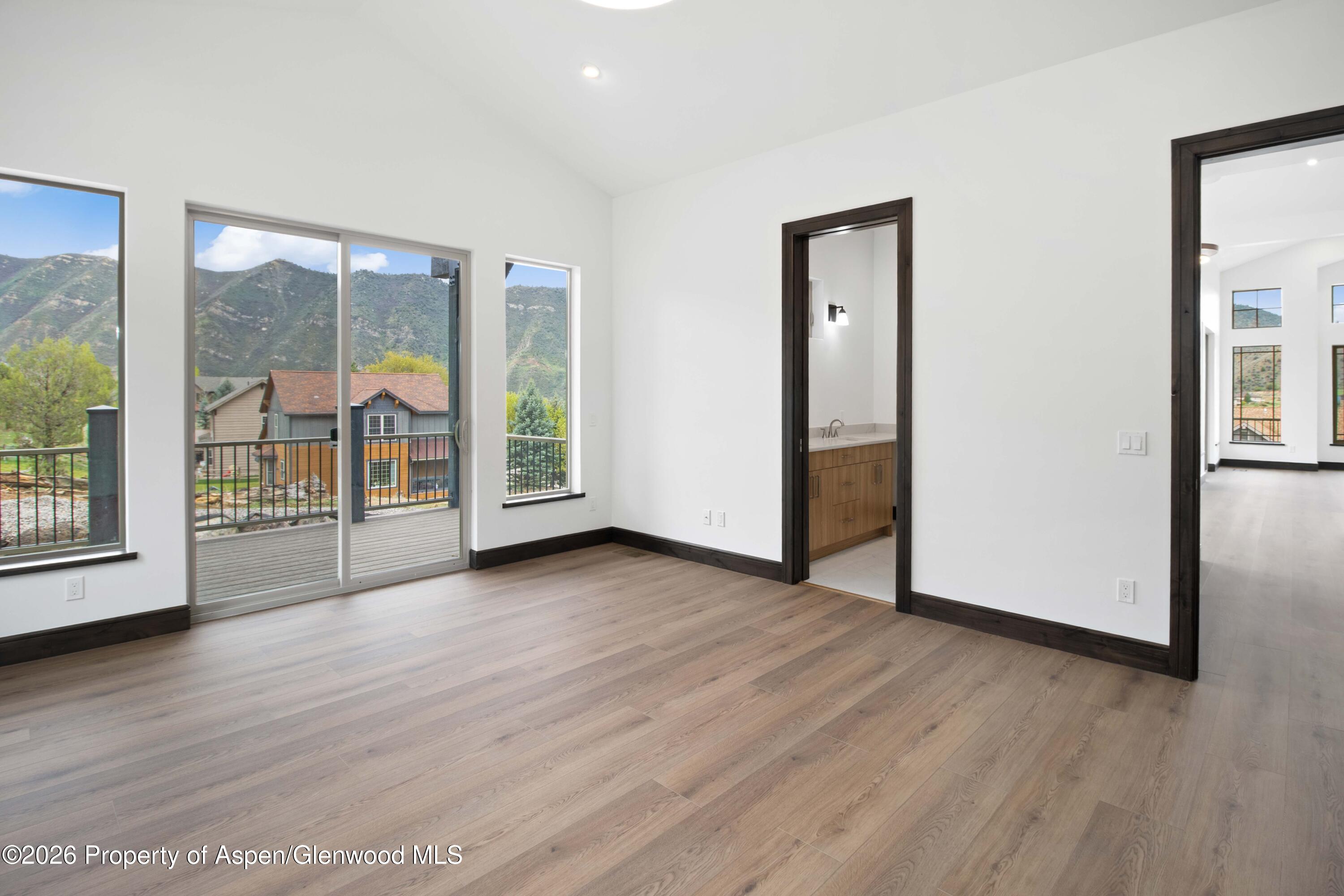342 Faas Ranch Road New Castle, CO 81647 - Photo 12 of 29 a view of an empty room with wooden floor and a window