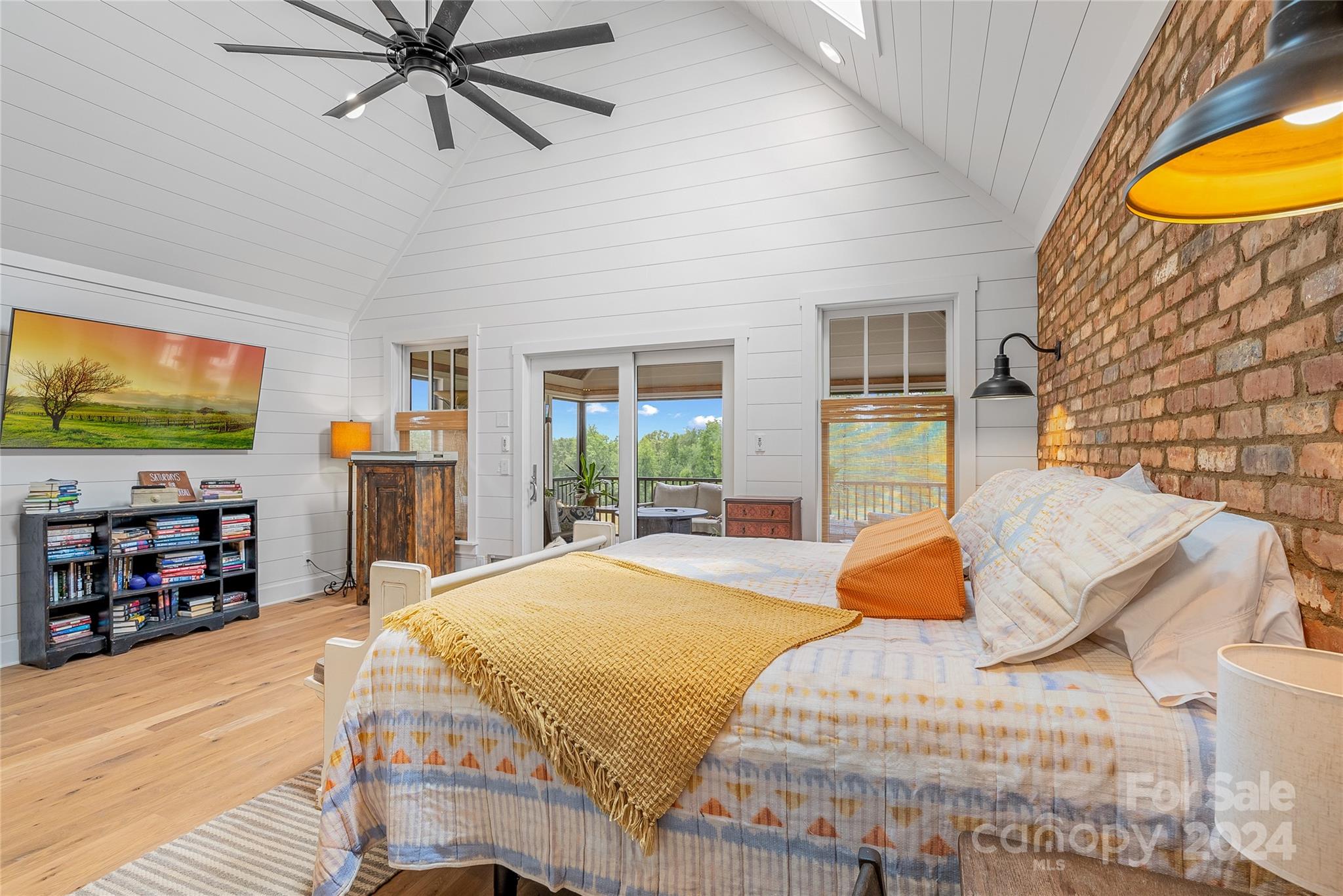 710 Tugaloo Road Landrum, SC 29356 - Photo 16 of 44 a bedroom with a bed and a flat screen tv