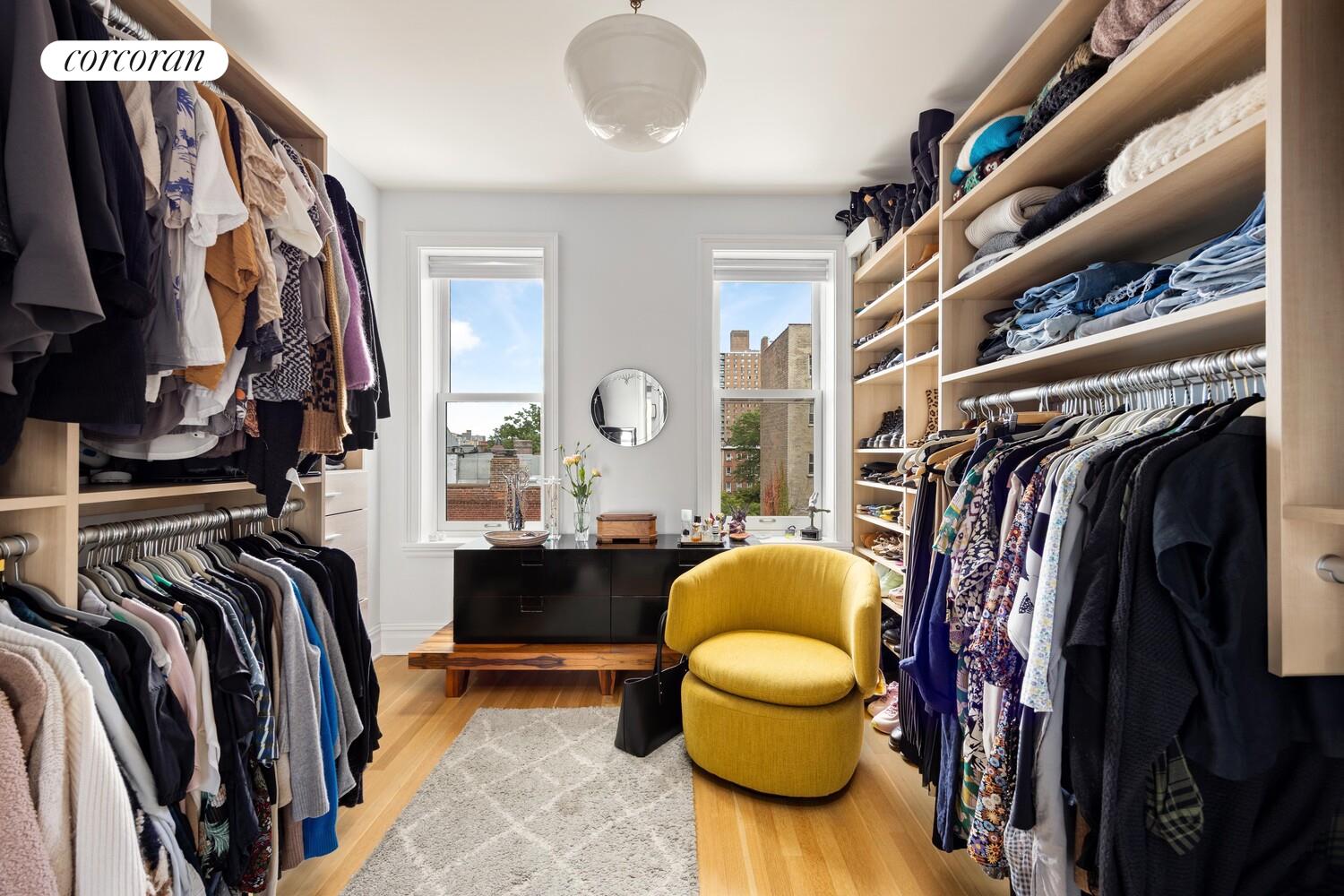 291 Clinton Avenue Brooklyn, NY 11205 - Photo 18 of 34 a view of walk in closet with clothes and shoes