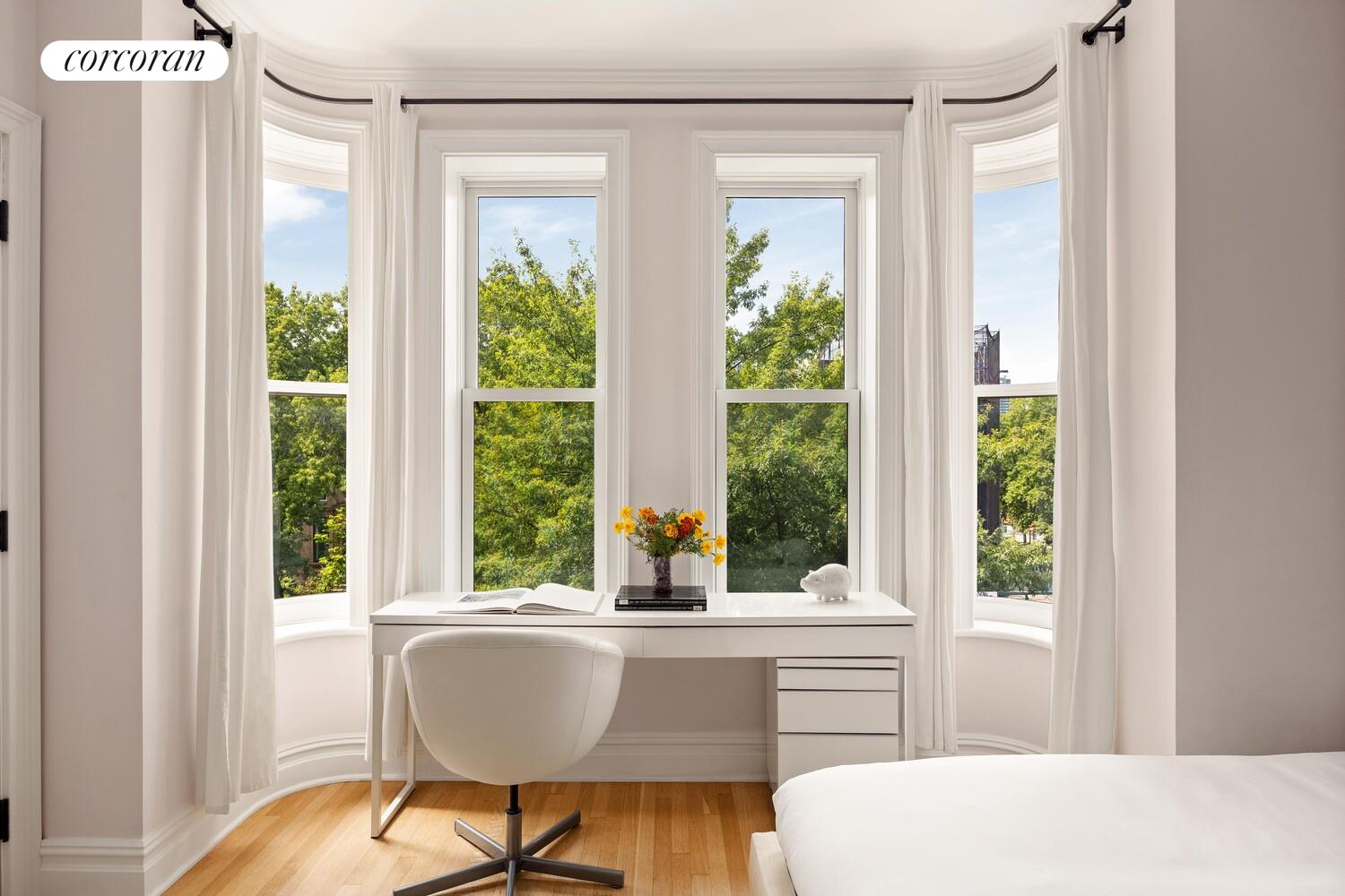 291 Clinton Avenue Brooklyn, NY 11205 - Photo 19 of 34 a living room with a large window and table