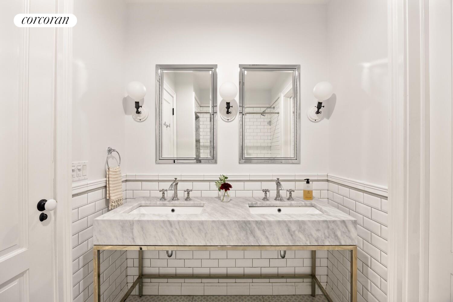 291 Clinton Avenue Brooklyn, NY 11205 - Photo 24 of 34 a bathroom with double vanity sink and a mirror