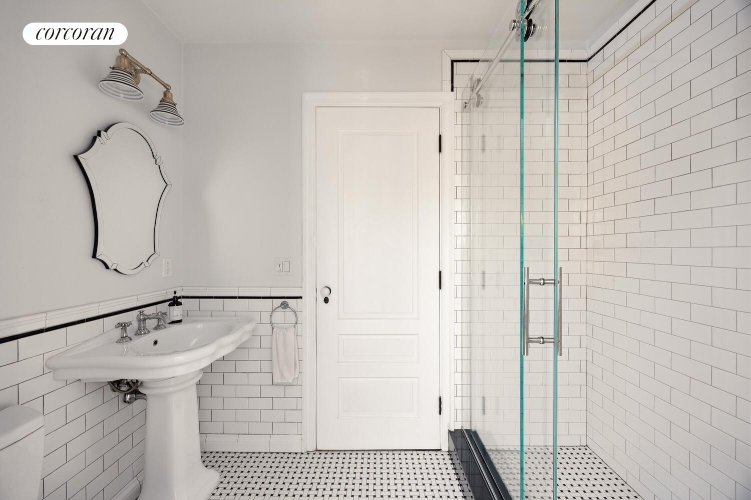 291 Clinton Avenue Brooklyn, NY 11205 - Photo 25 of 34 a bathroom with a shower and a mirror