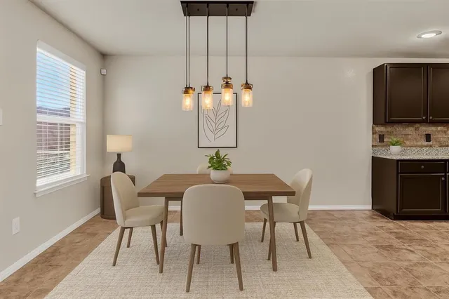 a dining room with furniture and window