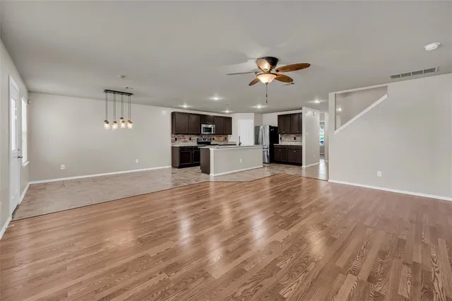 a view of a kitchen with a sink and a stove top oven