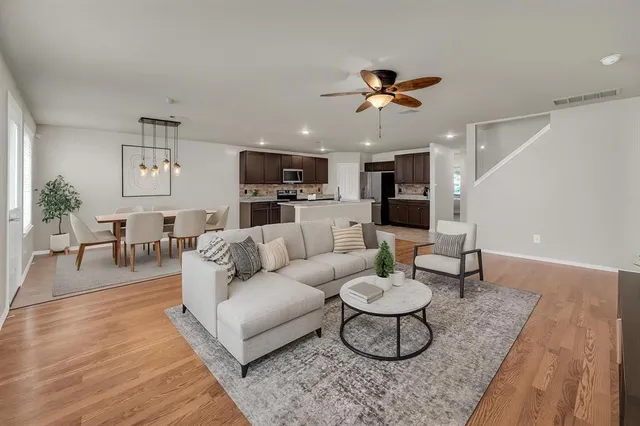 a living room with furniture a dining table and a fireplace