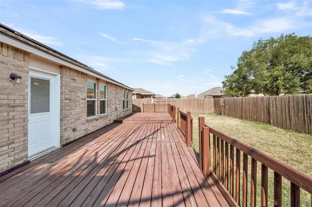 a view of a wooden deck front of house