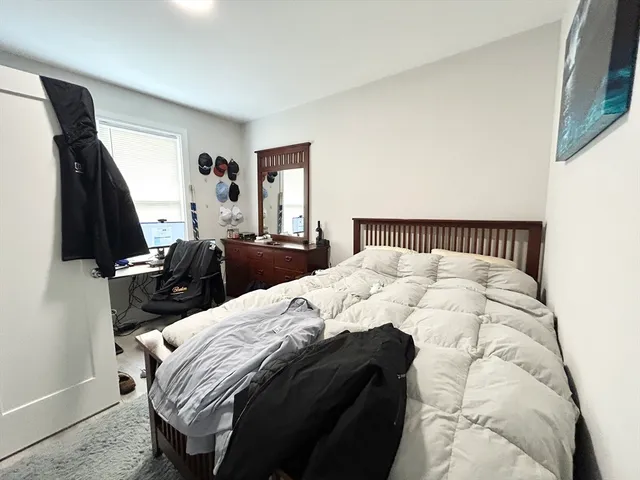 a bedroom with a bed and a mirror