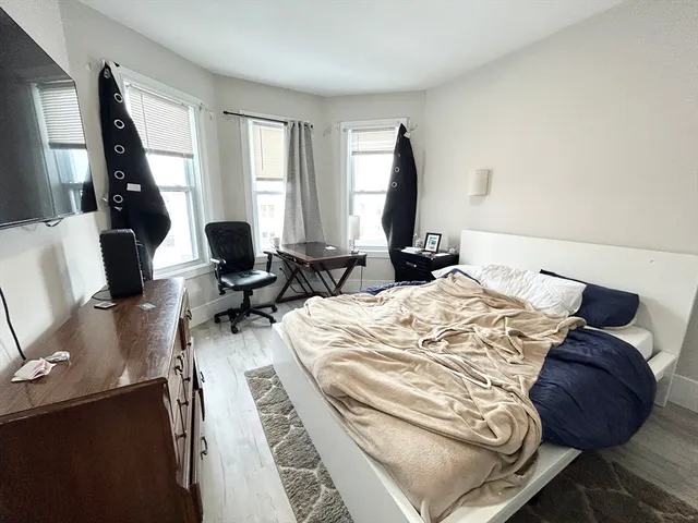 a bed sitting in a bedroom next to a window