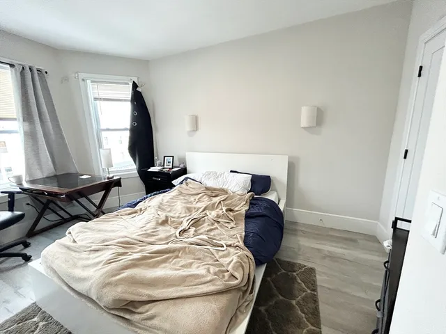 a bed sitting in a bedroom and mirror