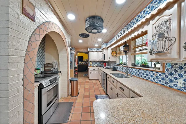 a kitchen with stainless steel appliances granite countertop a stove and a sink