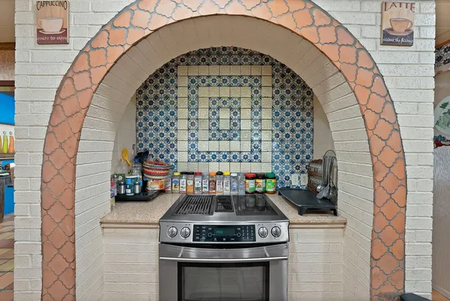 a stove top oven sitting inside of a kitchen