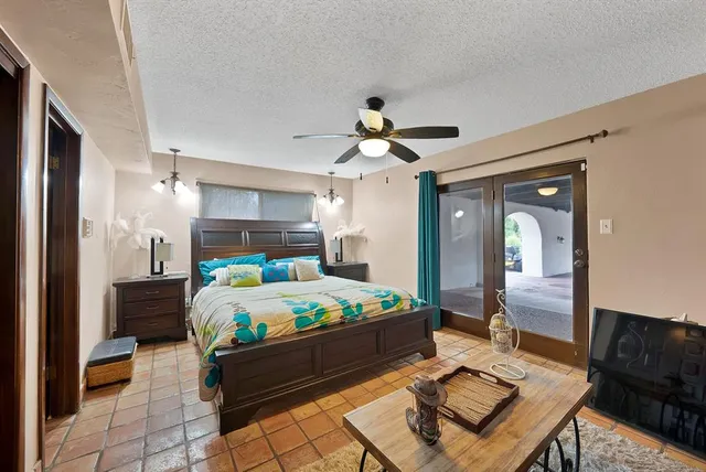 a bed room with a bed mirror and a desk