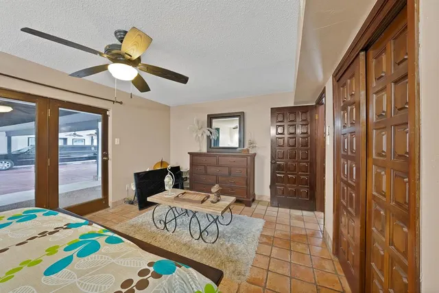 a bedroom with a bed and a chandelier