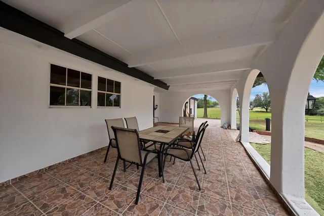 a dining room with furniture and window