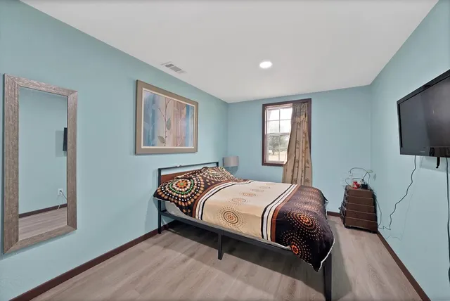 a bedroom with a bed and a flat screen tv