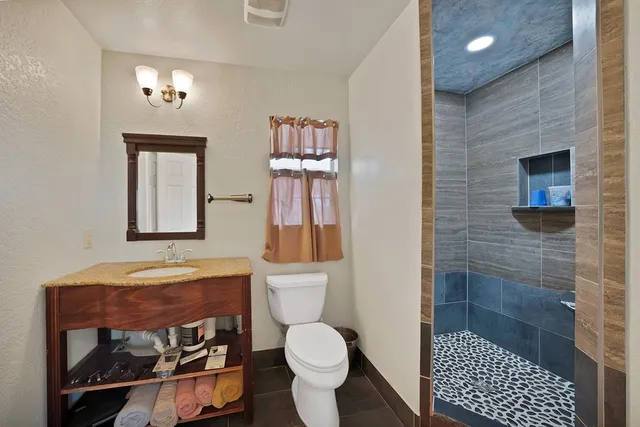 a bathroom with a toilet sink and shower