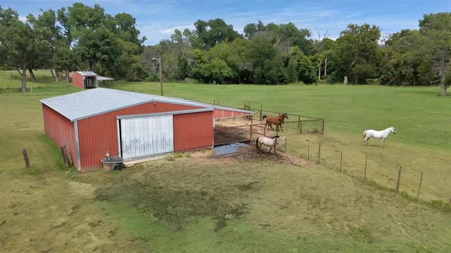 a view of a house with a yard and sitting area