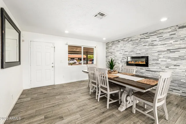 a kitchen with white cabinets stainless steel appliances and wooden floor