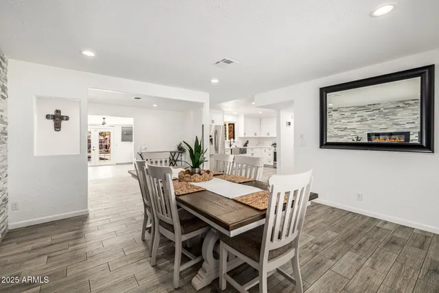 a kitchen with stainless steel appliances a refrigerator and wooden floor