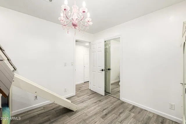 a view of a hallway with wooden floor and staircase