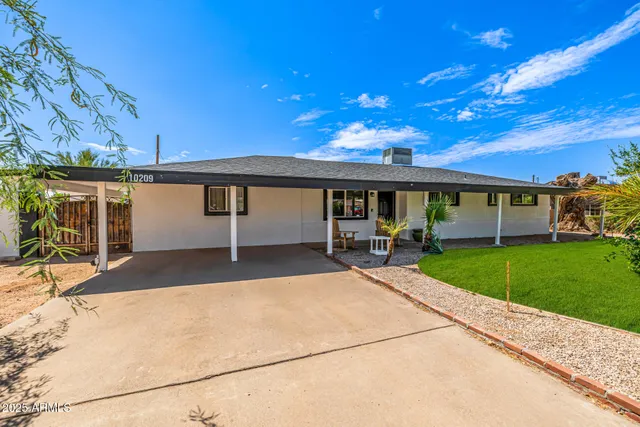 a view of a house with a yard porch and sitting area
