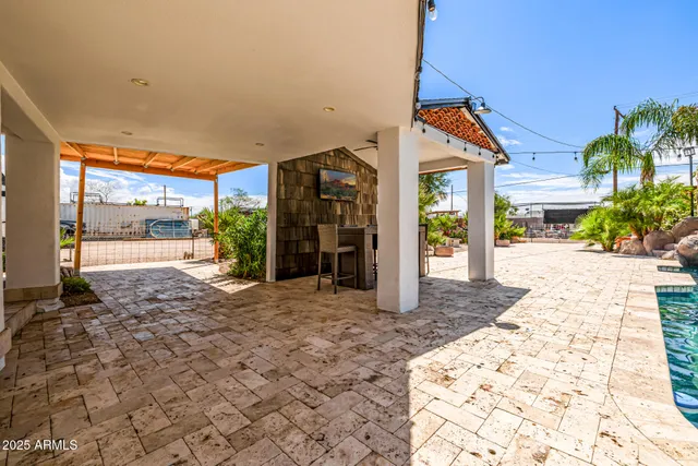 an aerial view of a house with a garden and lake view