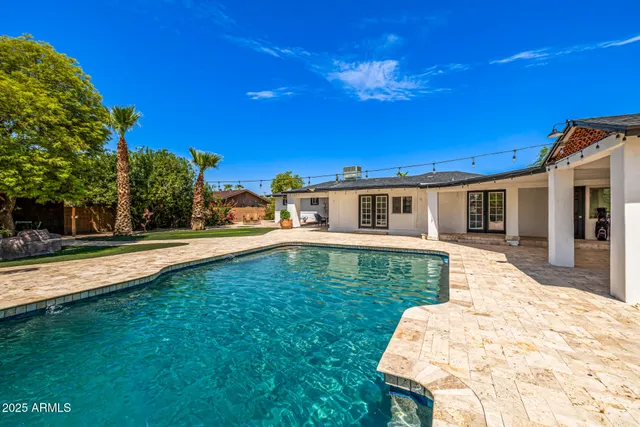 an aerial view of a house with a garden and swimming pool