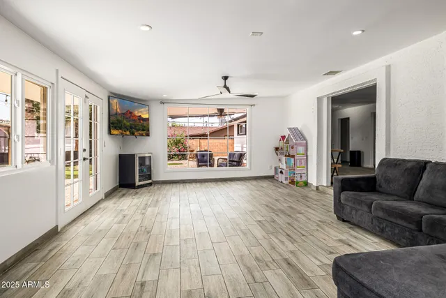 a living room with furniture and a wooden floor