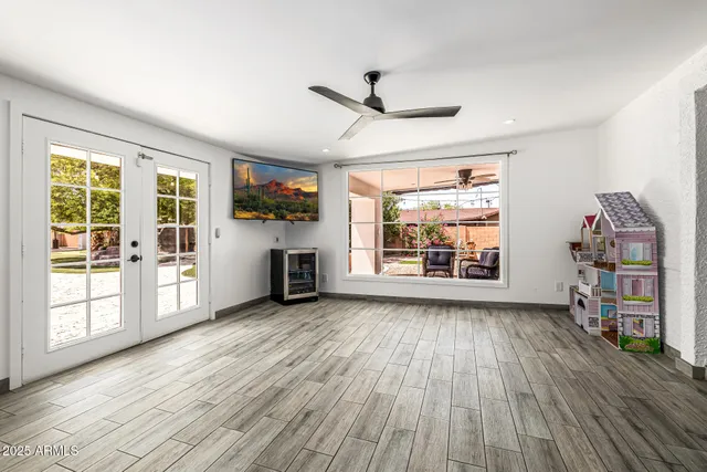 a living room with furniture and a wooden floor