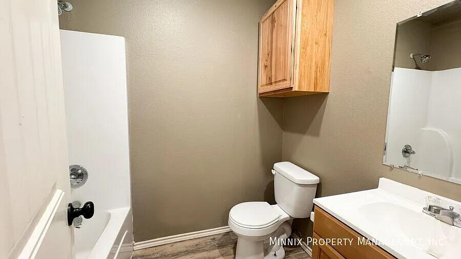 517 44th Street Lubbock, TX 79404 - Photo 10 of 10 a bathroom with a sink toilet and shower