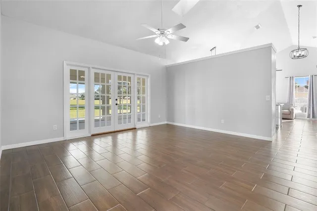 a living room with furniture and a floor to ceiling window