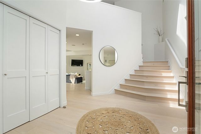 a view of a hallway with wooden floor and entryway