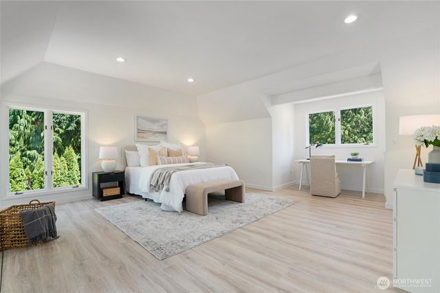 a spacious bedroom with a bed and a large window