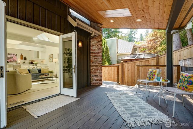 a view of a porch with wooden floor and furniture
