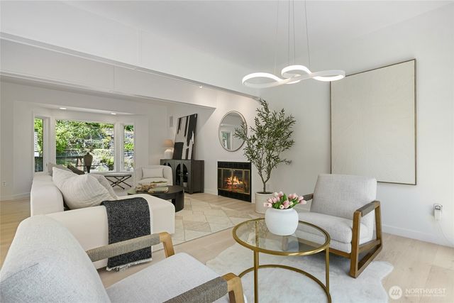 a living room with furniture a fireplace and a potted plant