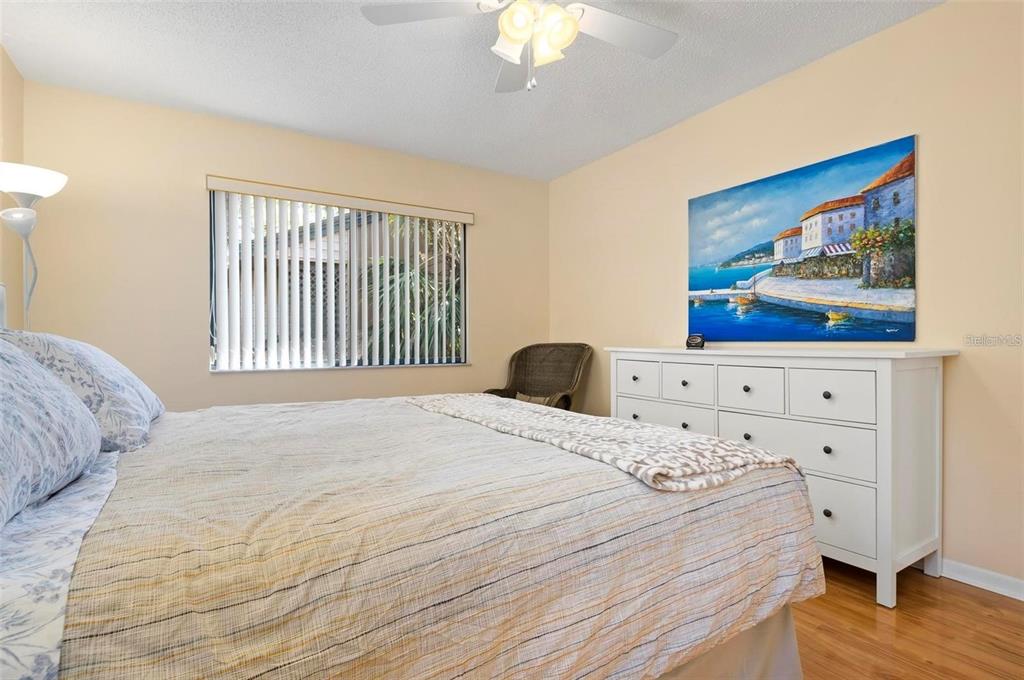1707 Pelican Cove Road, Unit 451 Sarasota, FL 34231 - Photo 12 of 24 a bedroom with a bed and a painting on the wall