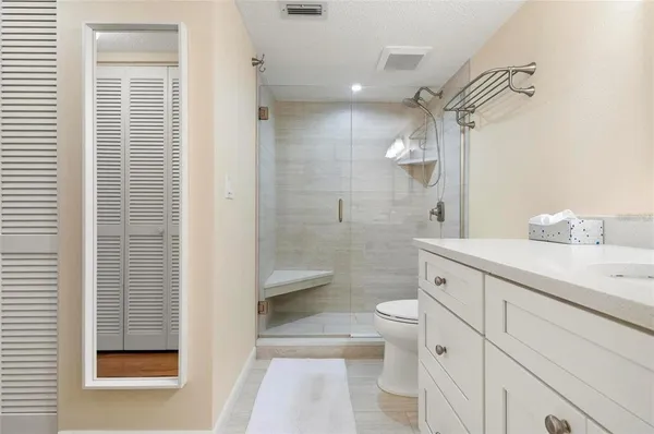 a bathroom with a sink a toilet and shower